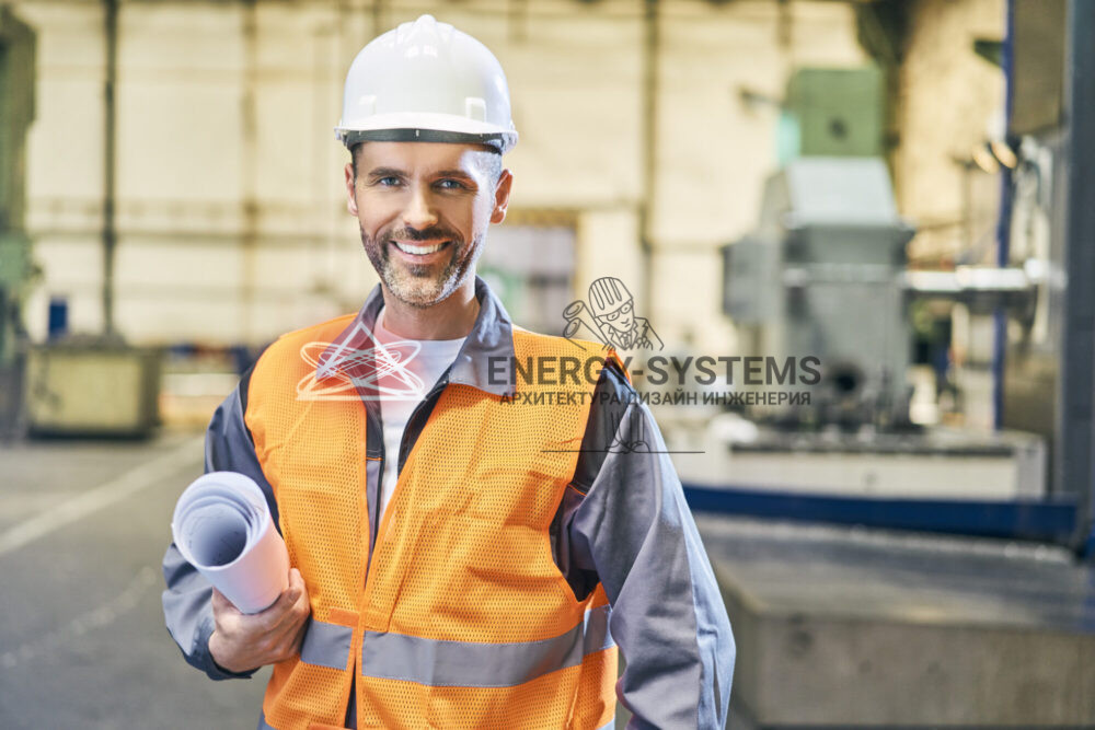 строитель в каске держит рулон с проектом