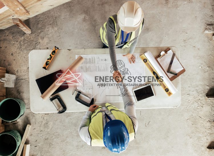 работники пожимают руки на фоне стола с проектом