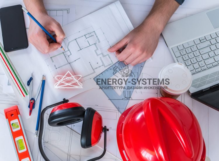 работник разрабатывает проект на столе с инструментами