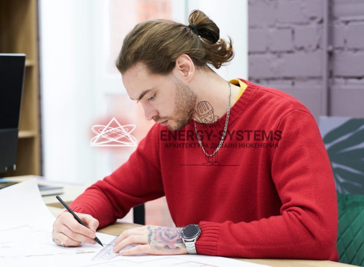 мужчина рисует проект за столом