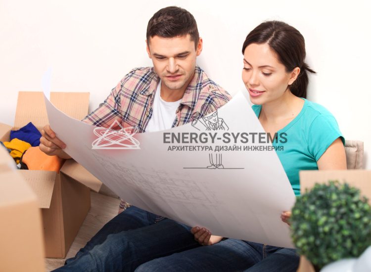 молодые люди смотрят в развернутый проект сидя на полу