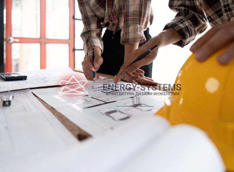 двое людей указывают карандашами в деталь проекта