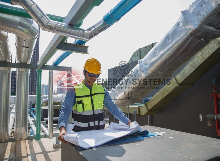 инженер изучает чертежи вентиляции