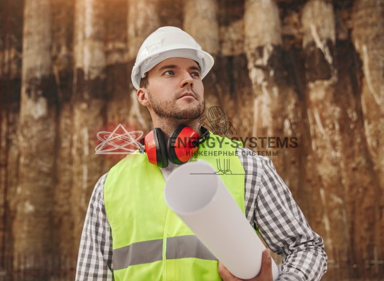 Серьезный строитель изучает проект инженерной системы